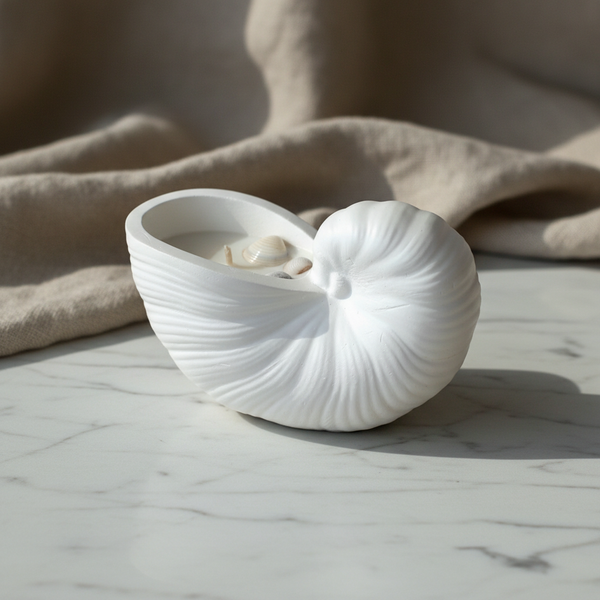 Vela aromática artesanal decorativa com motivos marítimos, feita à mão em búzio de cerâmica.