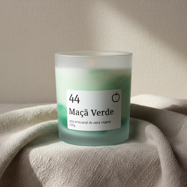 Vela aromática artesanal em copo de vidro fosco com aroma de maçã verde e efeito marmoreado verde escuro.