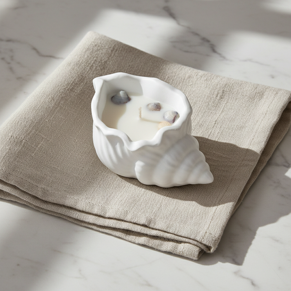 Vela aromática artesanal decorativa com motivos marítimos, feita à mão em búzio de cerâmica.